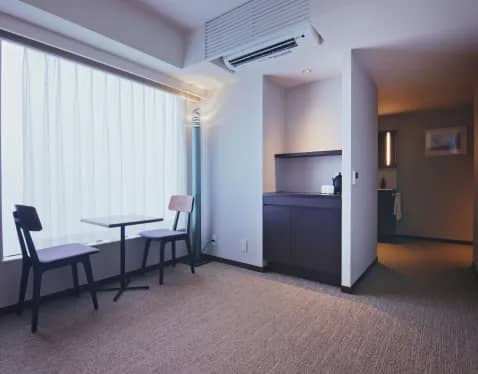 A room with a table and two chairs in it
