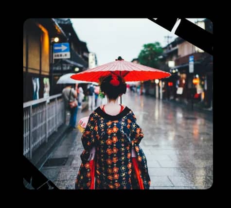 A woman walking down a street holding an umbrella
